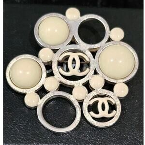 Vintage Chanel Metal Brooch with White Enamel CC Logos and Circular Detail